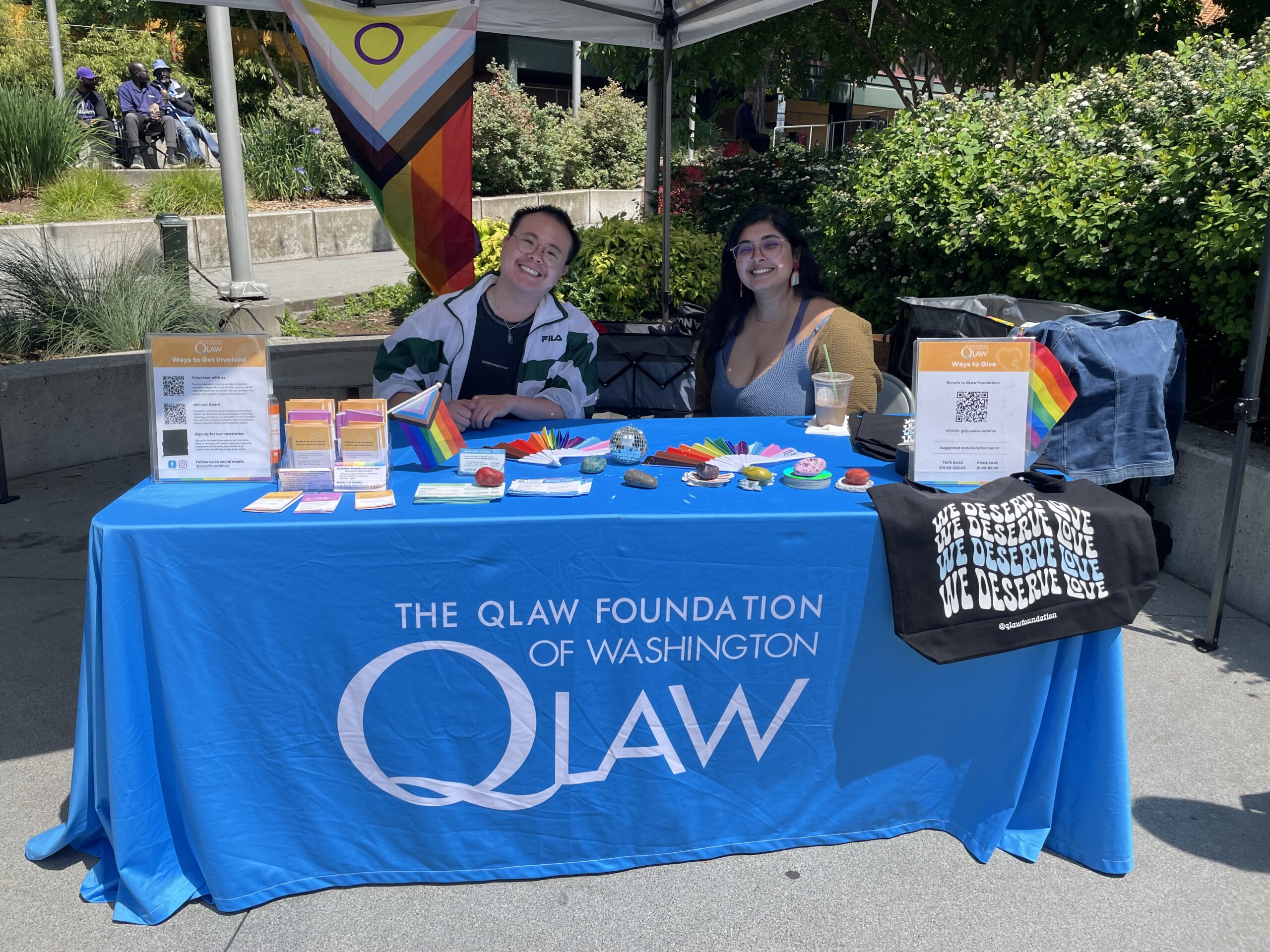 SWN+Mehera-Pride QLaw community members smiling while working at an event,